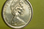 the head of queen elizabeth II on the front of an australian dollar coin