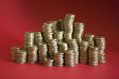 stacks of gold coloured coins on a red background