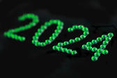 the year 2024 written out in green emerald jewels