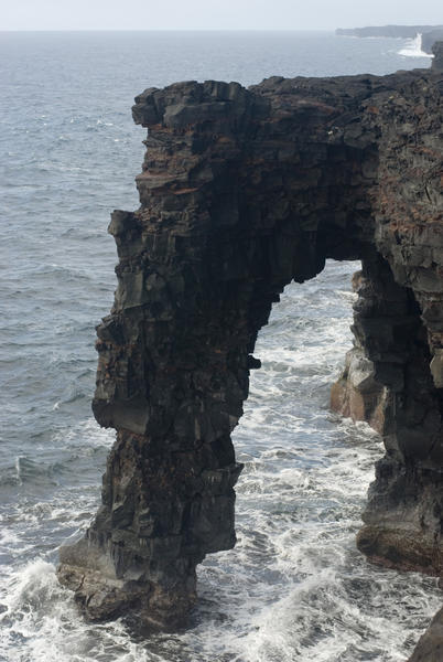 black volcanic rock arch at Holei on the coast of Hawaiis Big Island