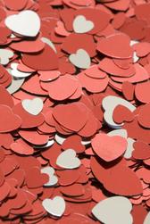 a background image featuring reflective heart shaped confetti in metallic silver and red colours