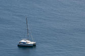 Luxury sailing catamaran moored offshore in mid ocean for a tropical vacation with copyspace