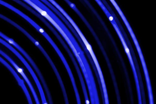 concentric curved blue coloured lines of light on a black background