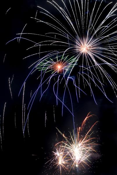 A long exposure image tracing shapes as fireworks explode during a fireworks display