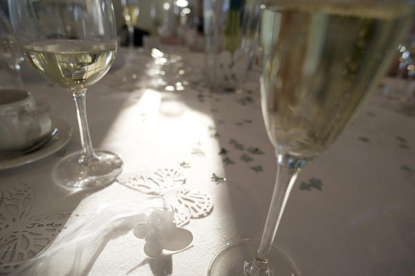 a wedding table and glass of champage ready for the wedding toast