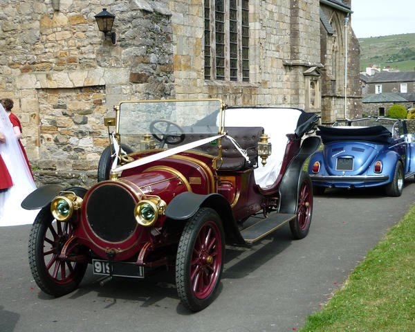 a vintage car being used at a wedding service